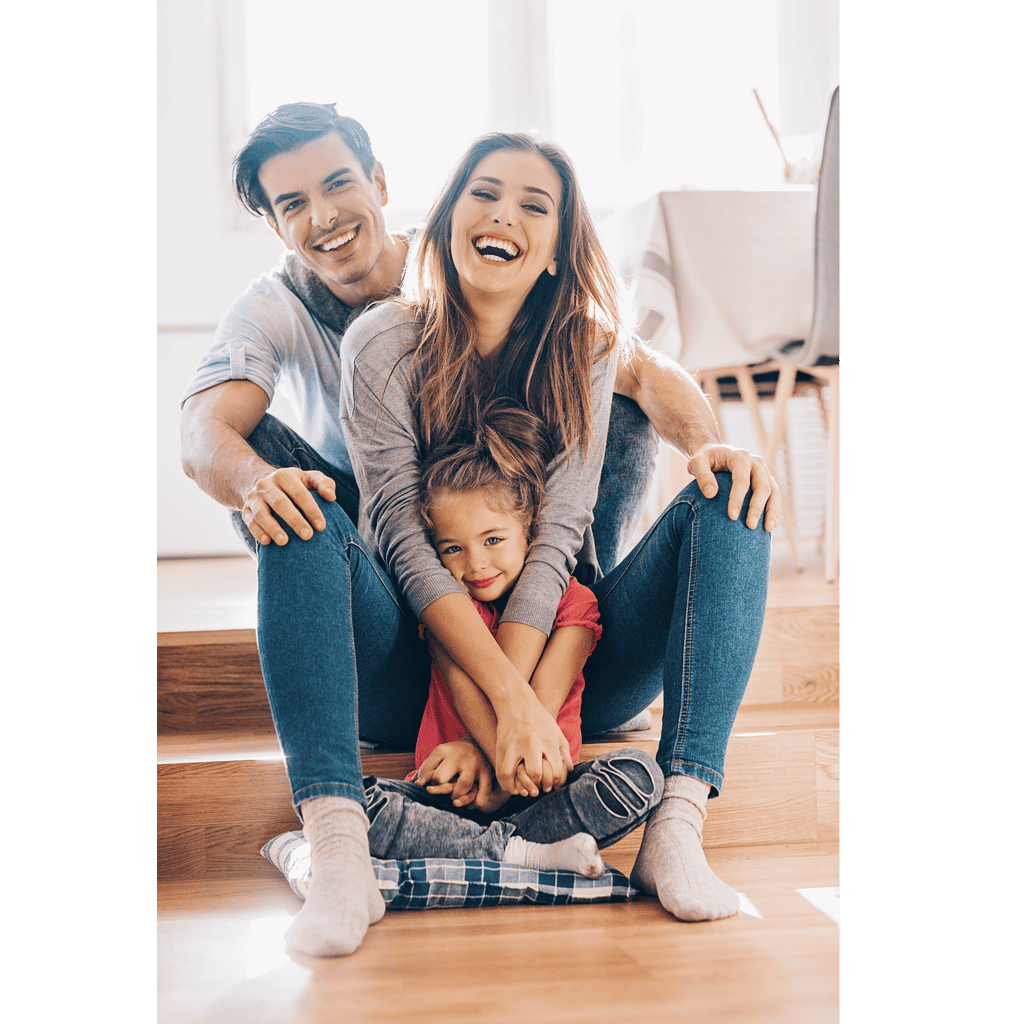 A family sitting in a house laughing